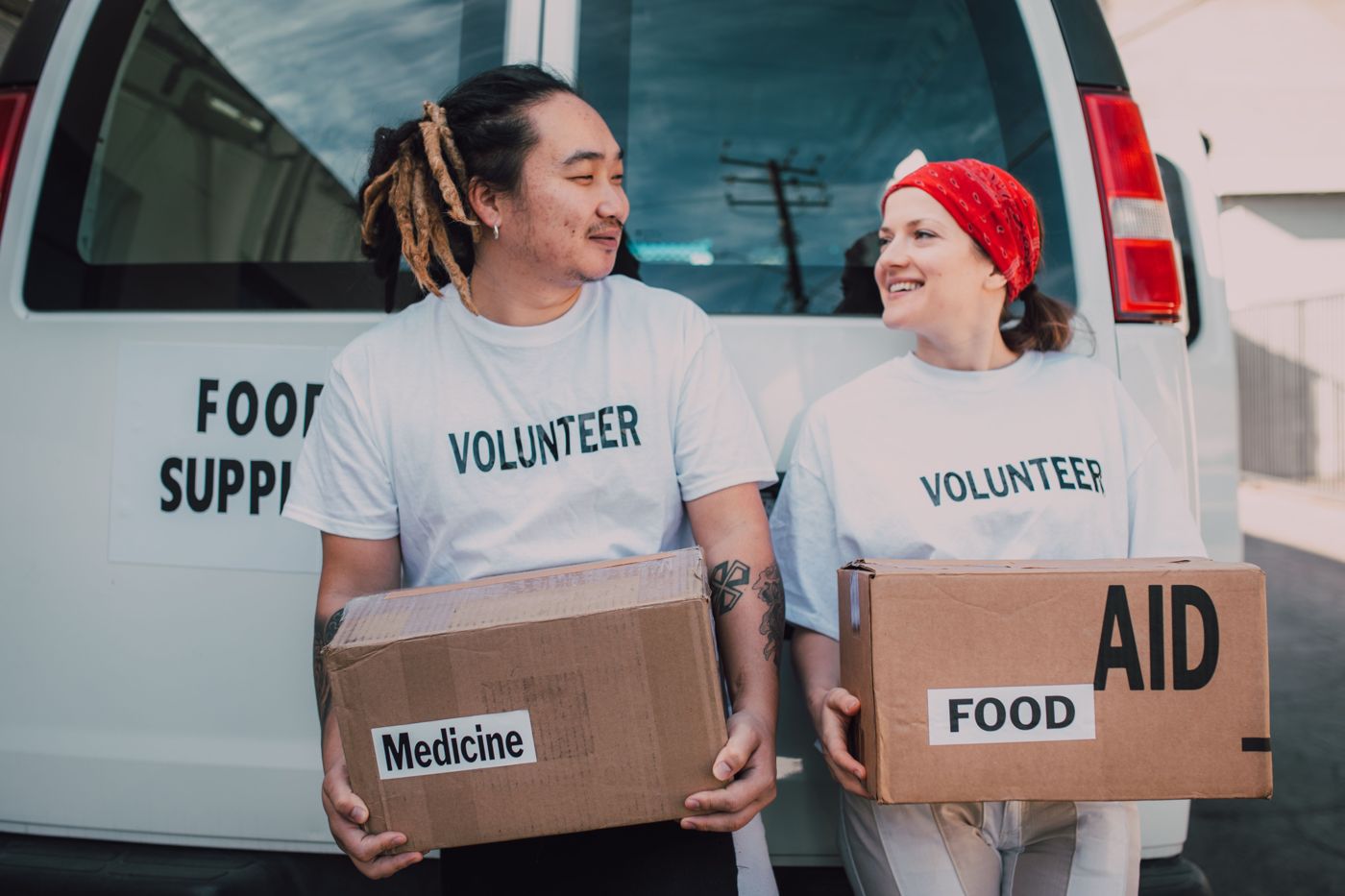 Volunteers carrying boxes of food and medicine